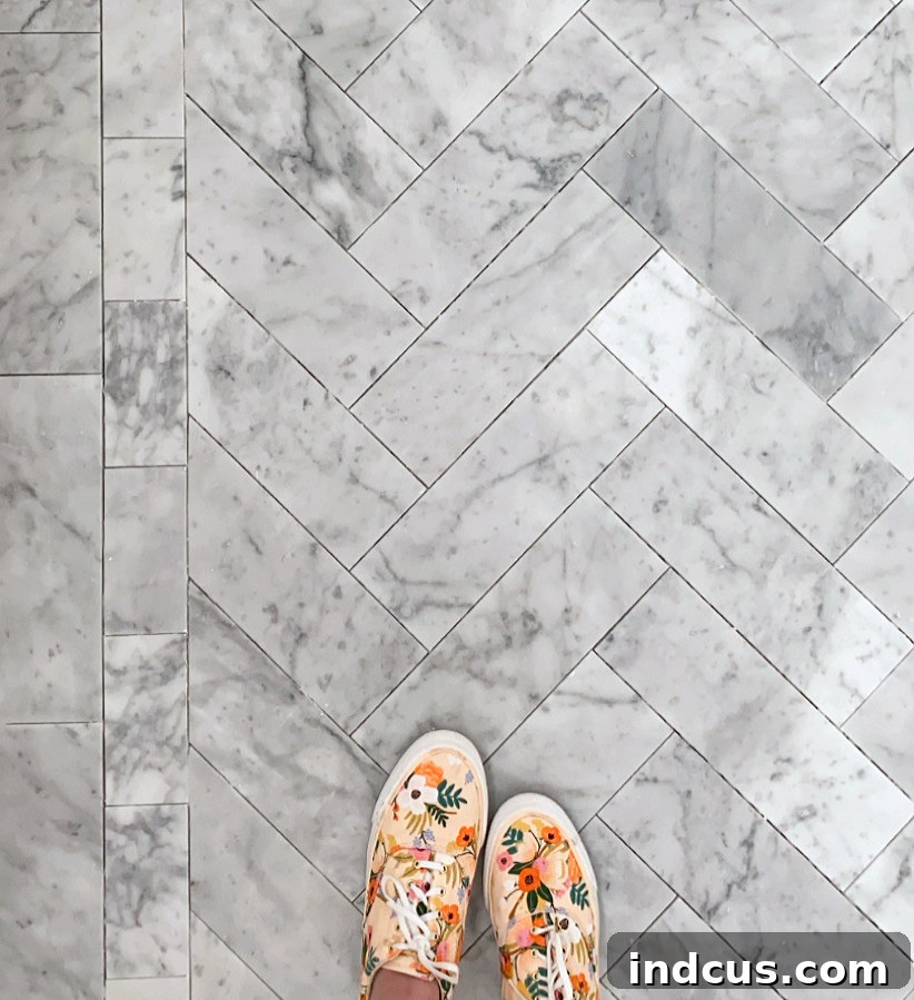 Bathroom floor with tiling progress and surrounding tools