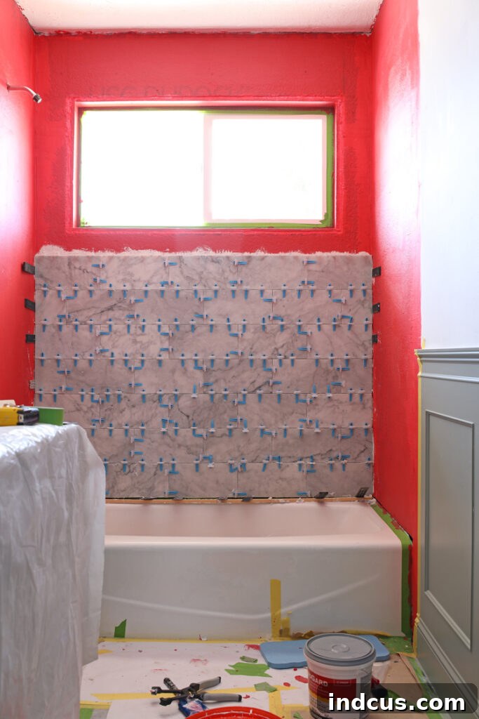 Before image of a dated hall bathroom, showing its old-fashioned decor and fixtures