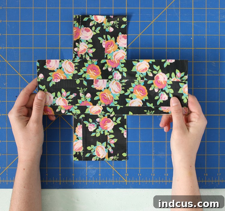 Two Duck Tape strips joined at their sticky centers to form a 'T' shape for the outer layer.