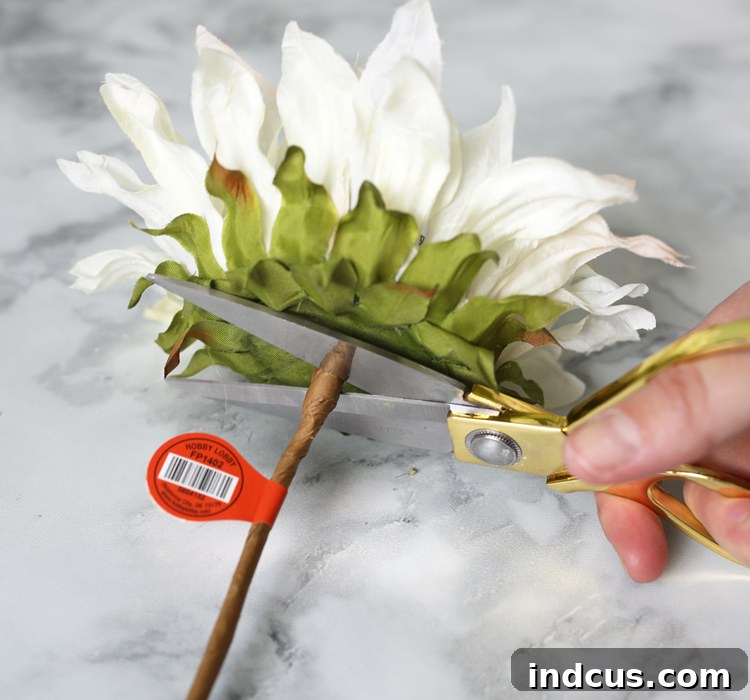 Crafting process: Painted sunflowers with trimmed stems neatly arranged, ready for assembly on a wreath base