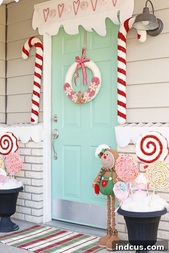 Front porch decorated for Christmas to resemble a gingerbread house, complete with gingerbread figures