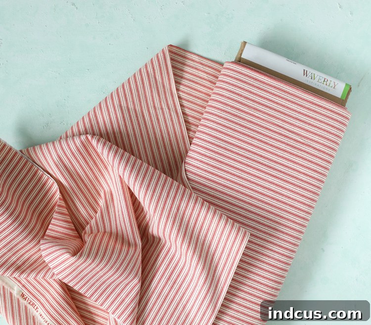 Close-up of red and white ticking stripe Waverly Inspirations fabric, ideal for DIY chair covers.