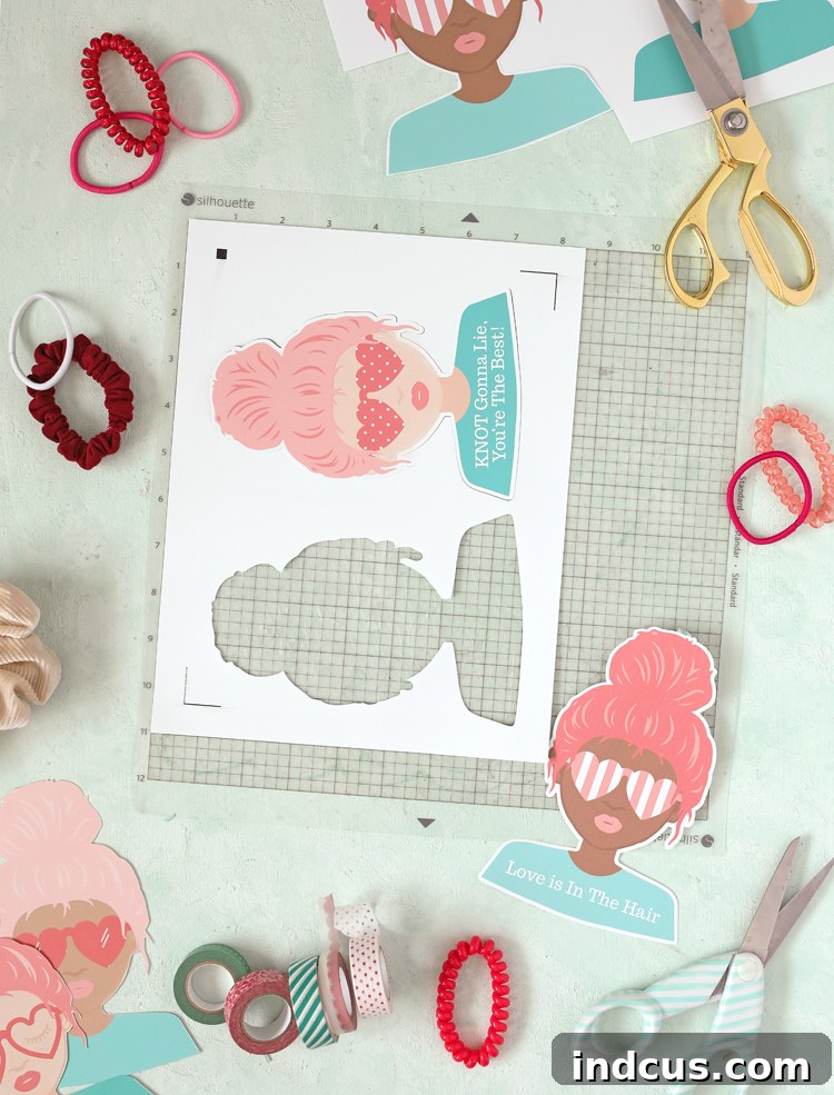 Silhouette machine cutting out the printable Valentine cards, highlighting the ease of using a print and cut feature.