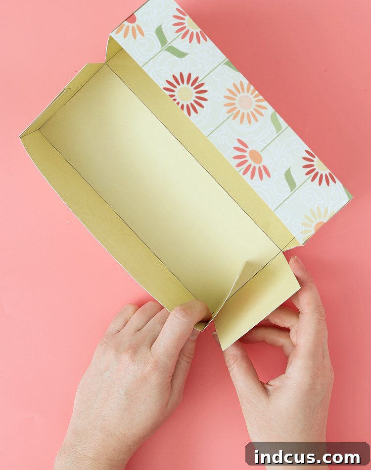 Final step: gluing sides to form the hinged lid of a paper treat box