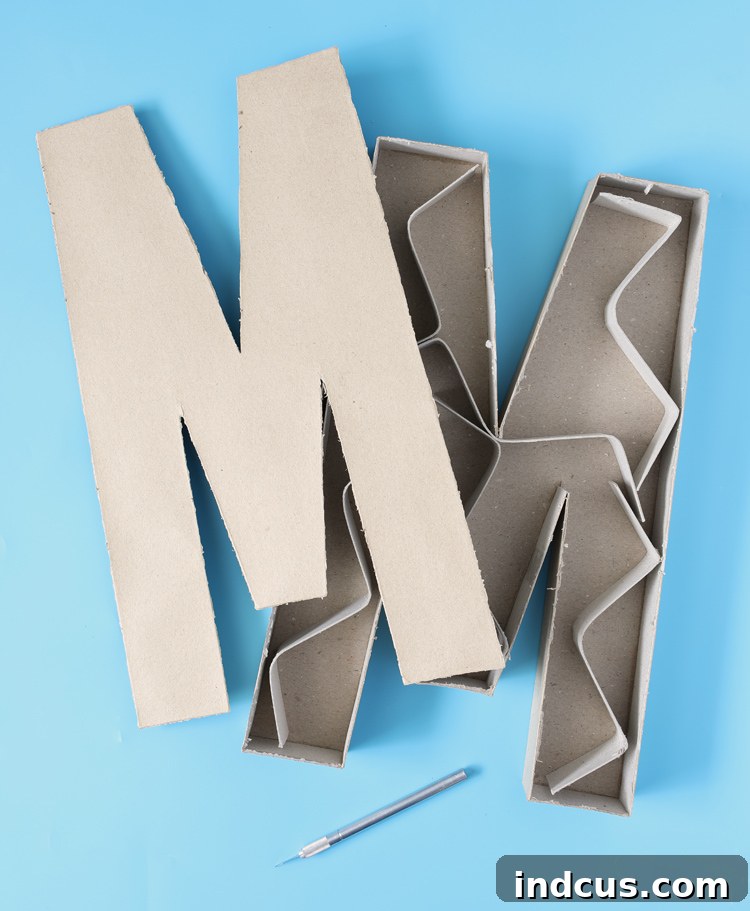 Cutting apart paper mache letters for a charcuterie board
