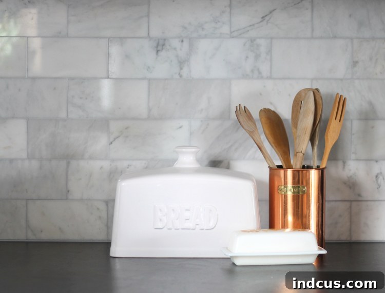 Finished marble subway tile backsplash in a traditional kitchen