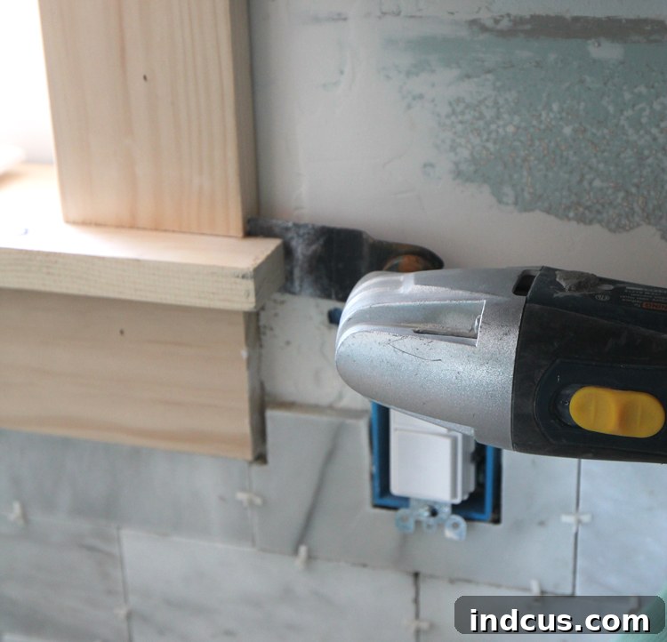 Using an oscillating tool to notch window trim for tile