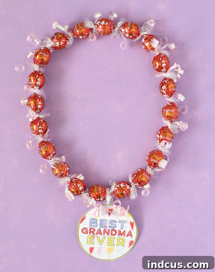 A vibrant, homemade candy lei crafted from Lindt Lindor Truffles, adorned with a custom coloring tag, perfect for a thoughtful gift.