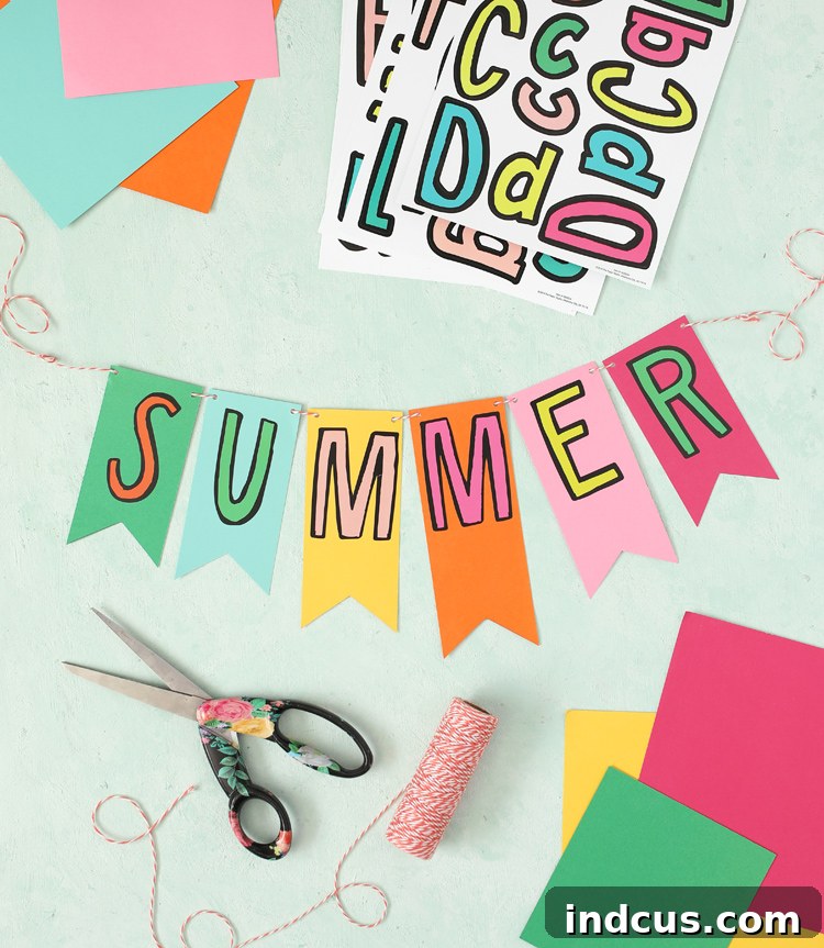 Close-up of a colorful 'SUMMER' banner crafted with cardstock and letter stickers for a kids' activity basket