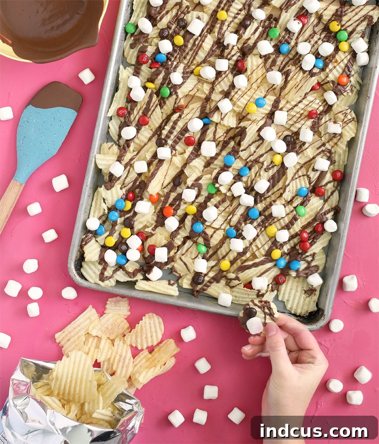 Delicious chocolate covered potato chip snack mix with colorful M&Ms and fluffy mini marshmallows