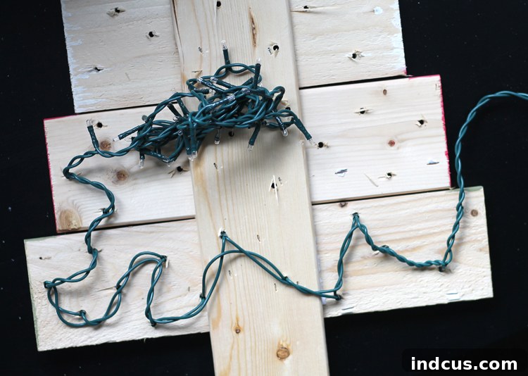 Adding string lights to a wooden decoration
