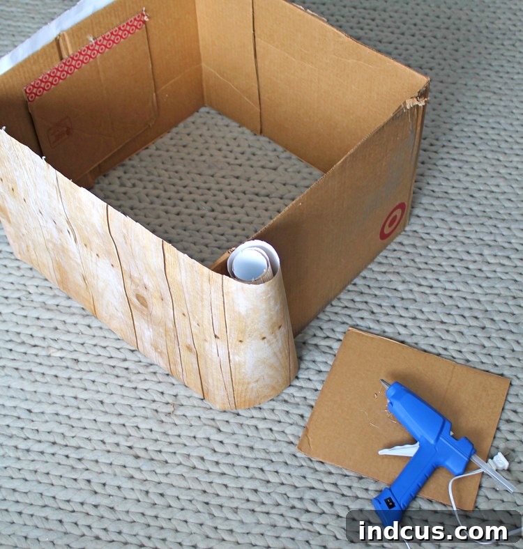 DIY Rustic Barnwood Tree Skirt 3 Applying rustic wood bulletin board paper to cardboard for DIY Christmas tree collar