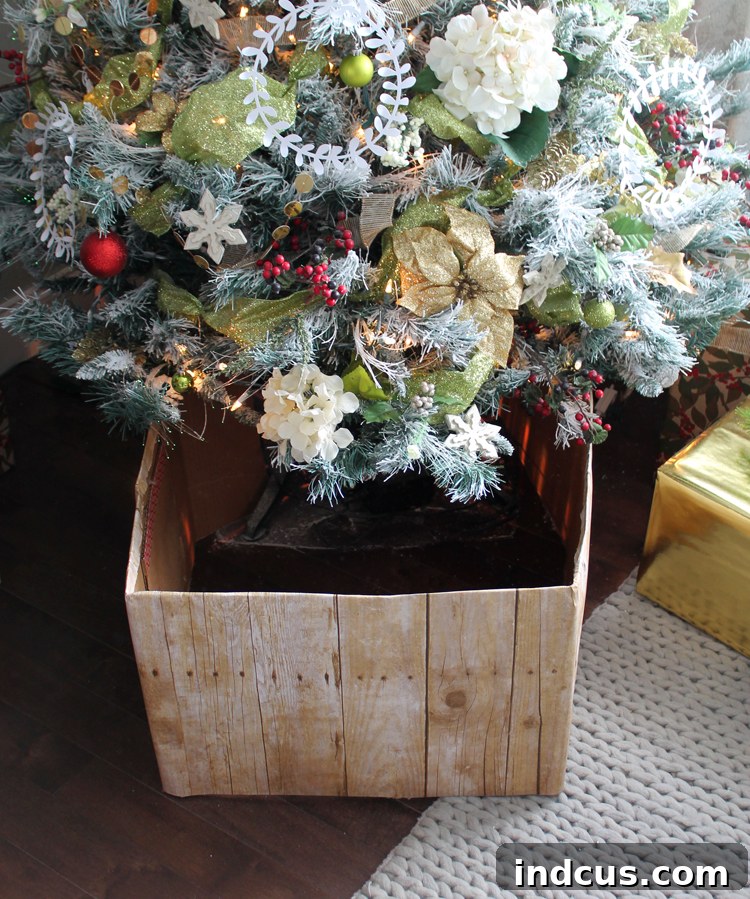 Alternative Christmas tree skirt that looks like a wood box Securing a DIY tree collar made from an old cardboard box with a binder clip