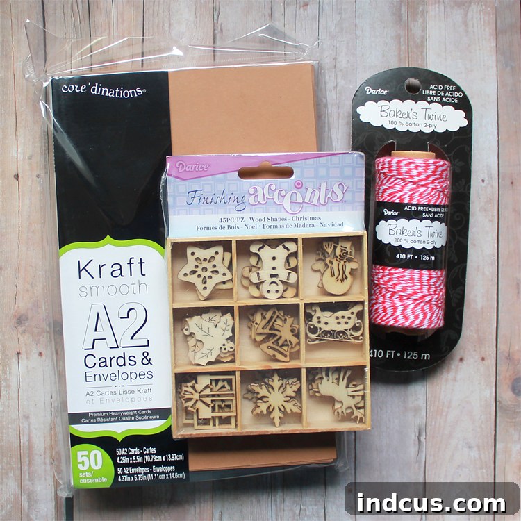 Christmas card making supplies: kraft paper cards, wooden festive shapes, and red baker's twine