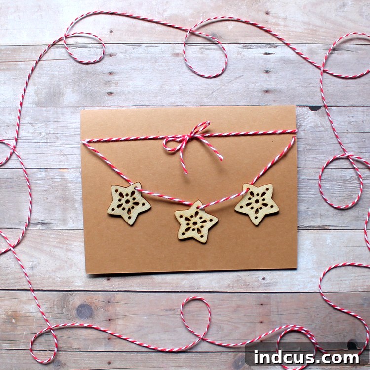 Christmas card with multiple wooden snowflakes and red baker's twine details