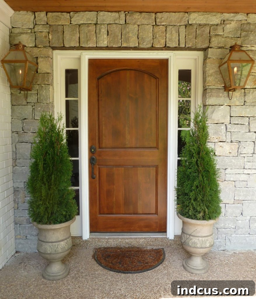 Tall cedar tree topiaries framing a doorway