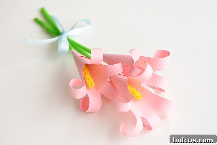 An elegant paper handprint lilies craft, demonstrating how to make beautiful paper lilies for Mother's Day.