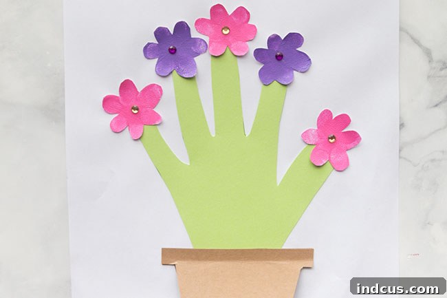 A Mother's Day handprint flower pot card, featuring a delightful pop-up surprise note inside.