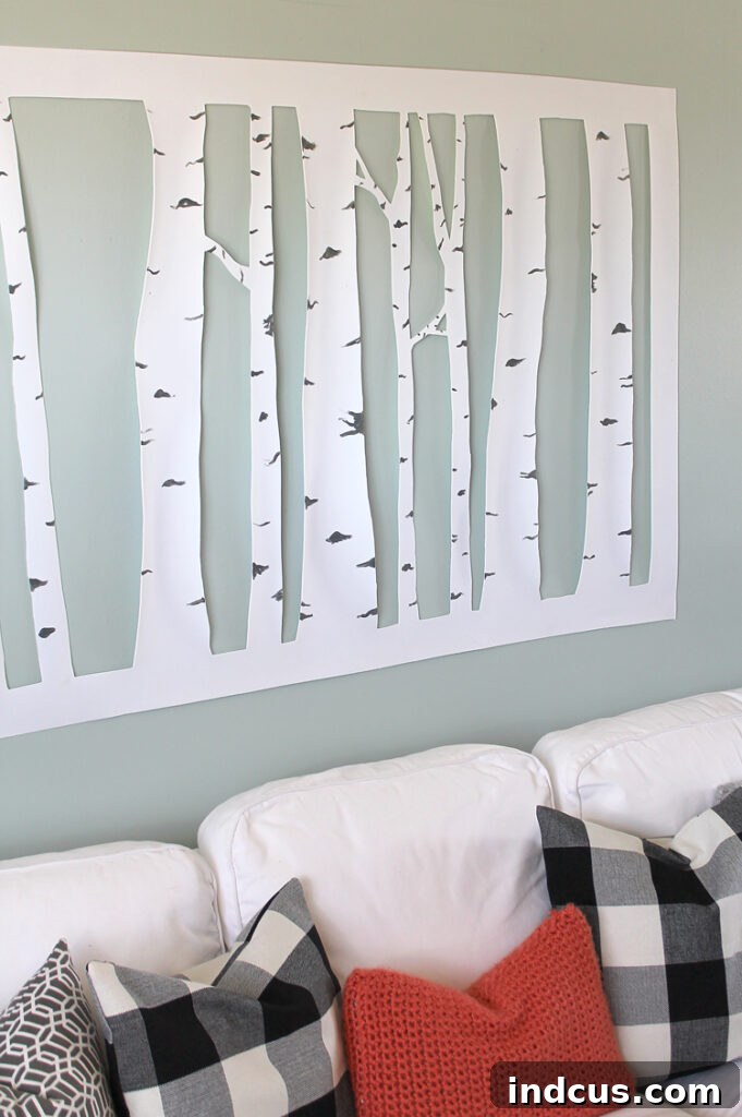 A large-scale DIY aspen tree wall art piece made from craft foam, hung in a modern living room, showcasing its dimensional quality against a light-colored wall.