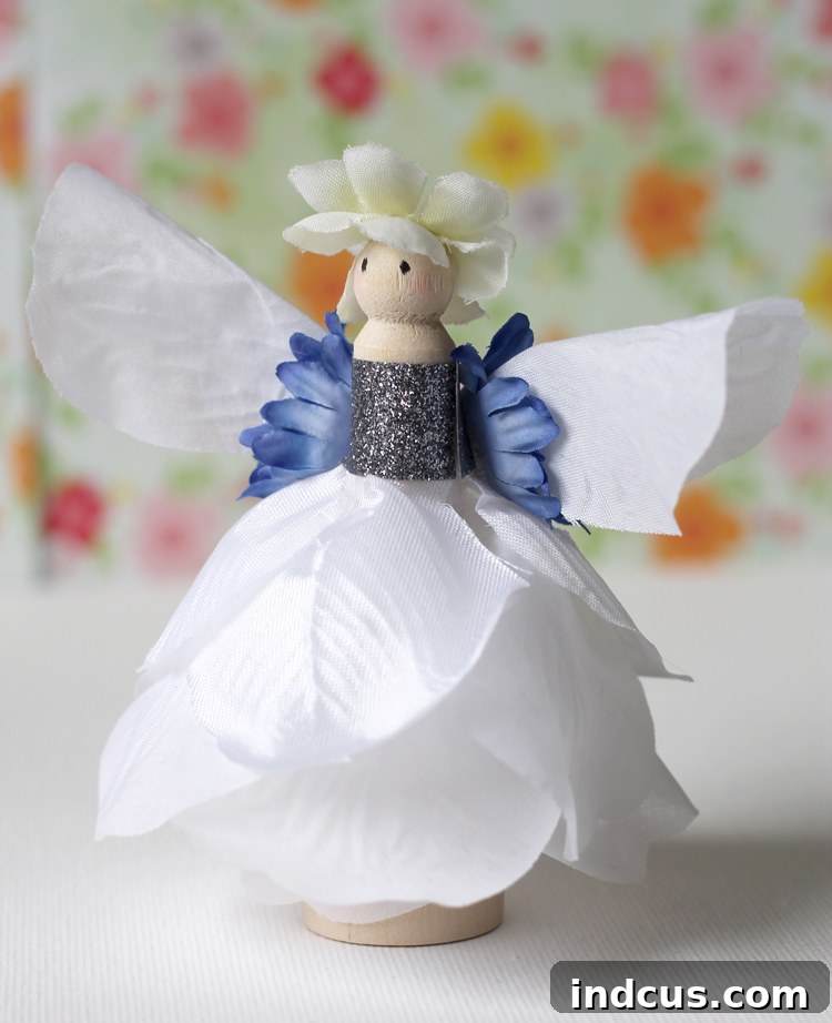 Exquisite white rose fairy crafted from a wooden doll peg and silk flowers, showcasing elegant design.