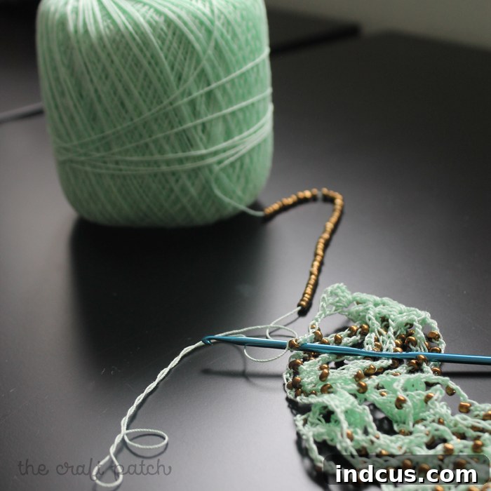 Crochet thread with numerous beads strung, ready for crocheting