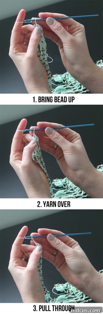 Detailed image showing a bead being crocheted into a chain stitch