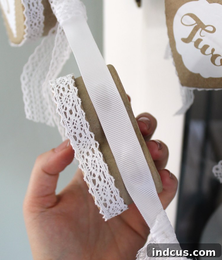 Attaching heart boxes to the ribbon with hot glue for the garland