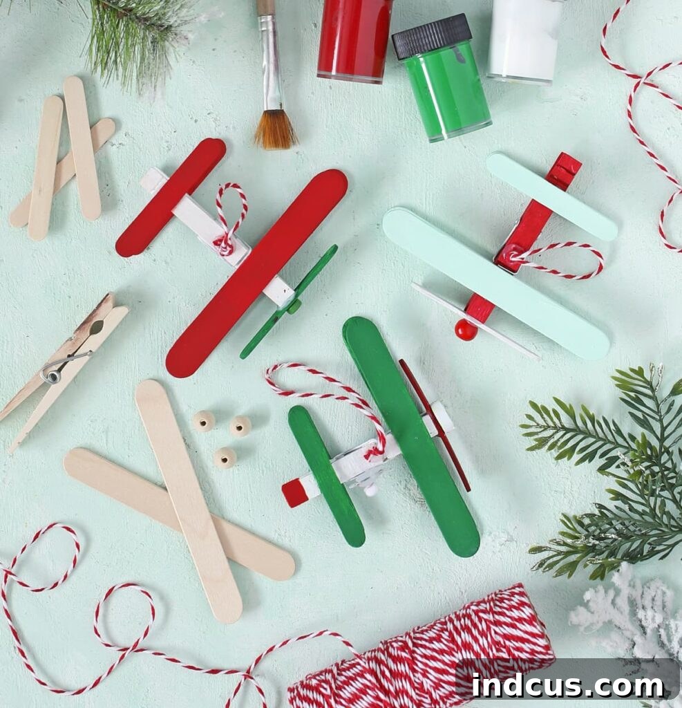 Craft stick Christmas craft showing a completed airplane ornament ready for hanging