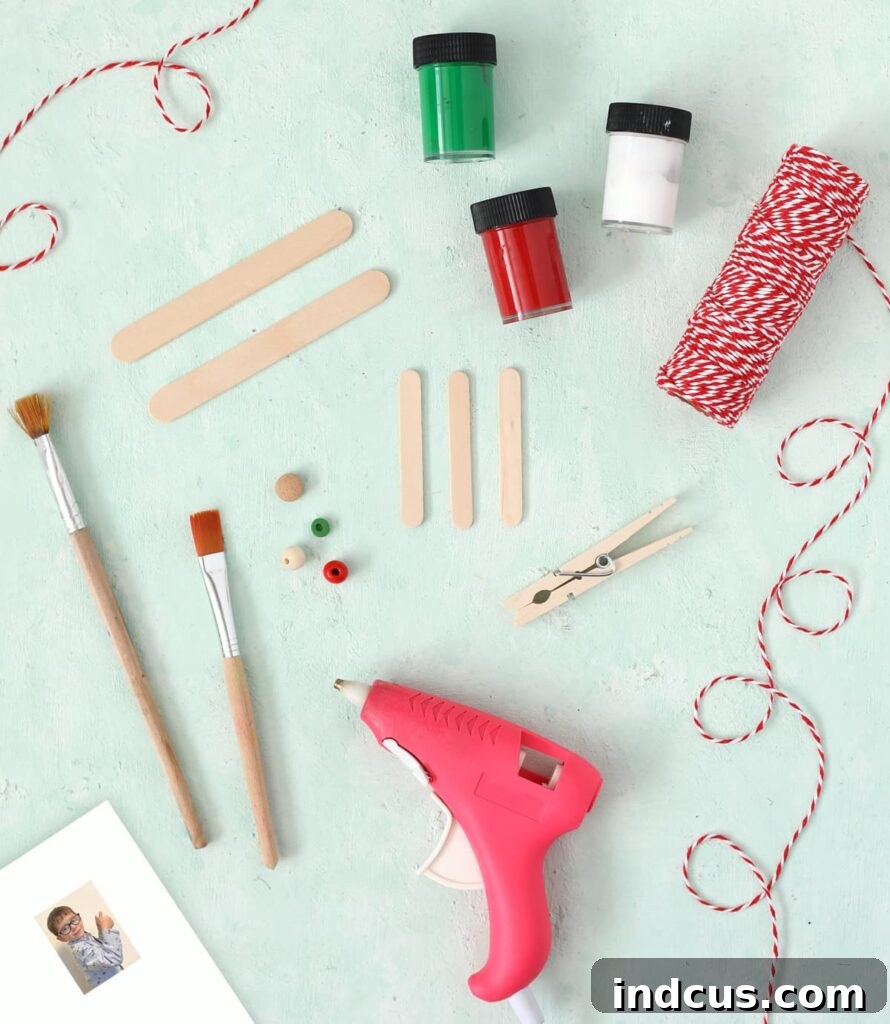 Materials needed for popsicle stick airplane ornament including craft sticks, clothespin, and glue