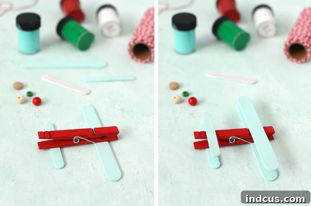 Close-up showing how to attach popsicle stick wings to a wooden clothespin for the airplane craft