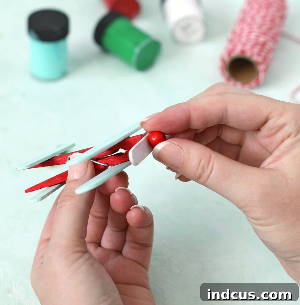 Detailed view of assembling the propeller and tail of the popsicle stick airplane ornament
