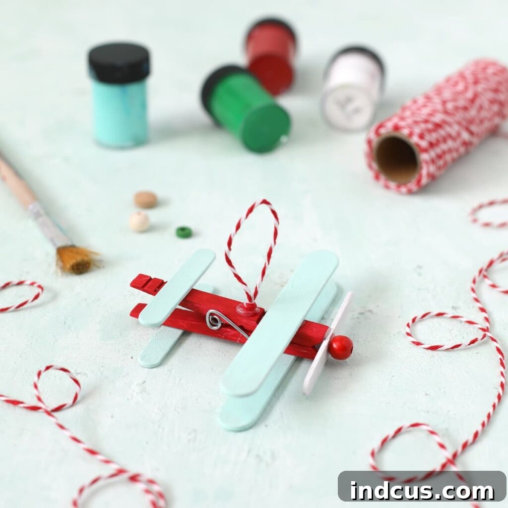 Adding baker's twine loop for hanging the airplane popsicle stick craft ornament
