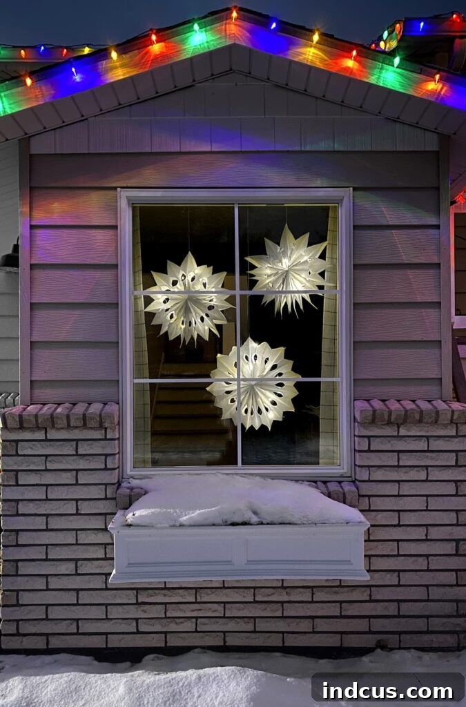 Glimmering Paper Star Lanterns 12 A close-up of a glowing paper bag star radiating warmth and light in a darkened room, seen from a window