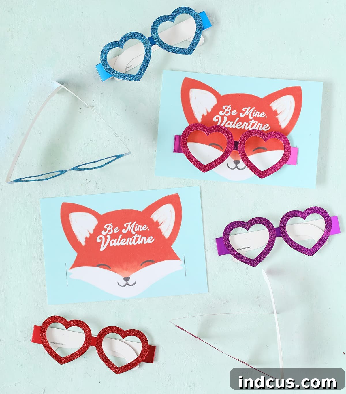 Printable fox Valentine's Day card with red glitter heart glasses cleverly inserted through slits in the card to sit on the fox's face.
