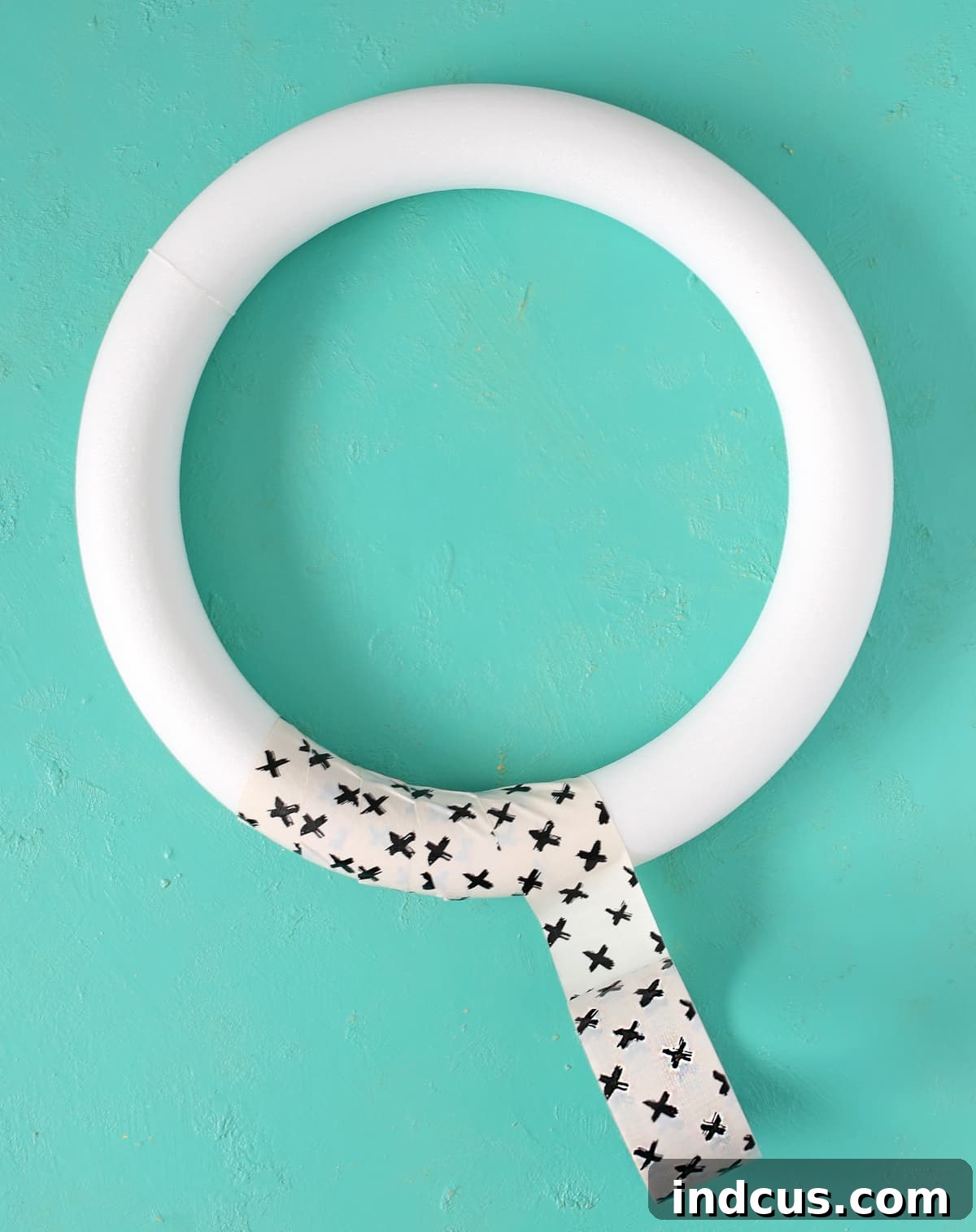 Wrapping a foam wreath form with patterned Duck Tape for a smooth finish