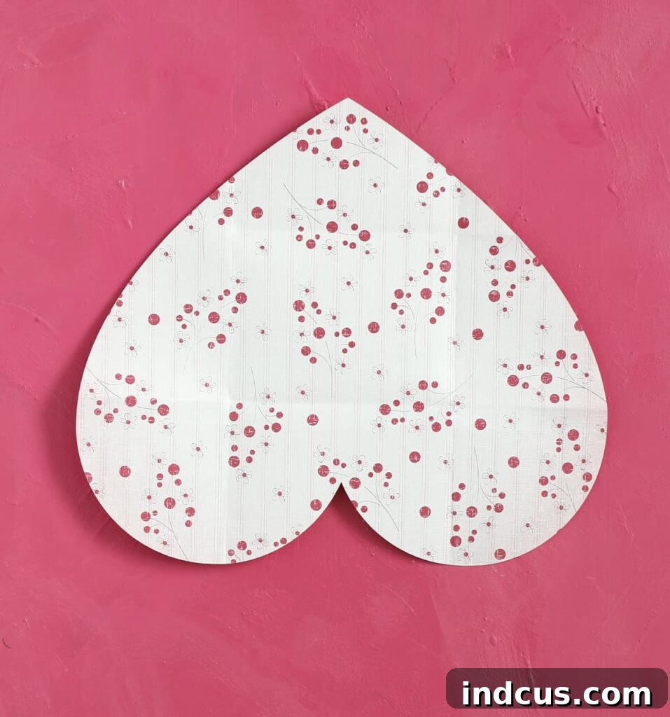 Craft Your Own Heart Envelope 3 Begin by cutting a large, symmetrical heart shape from your chosen colorful paper. Then, turn the heart upside down, so the point faces downwards.