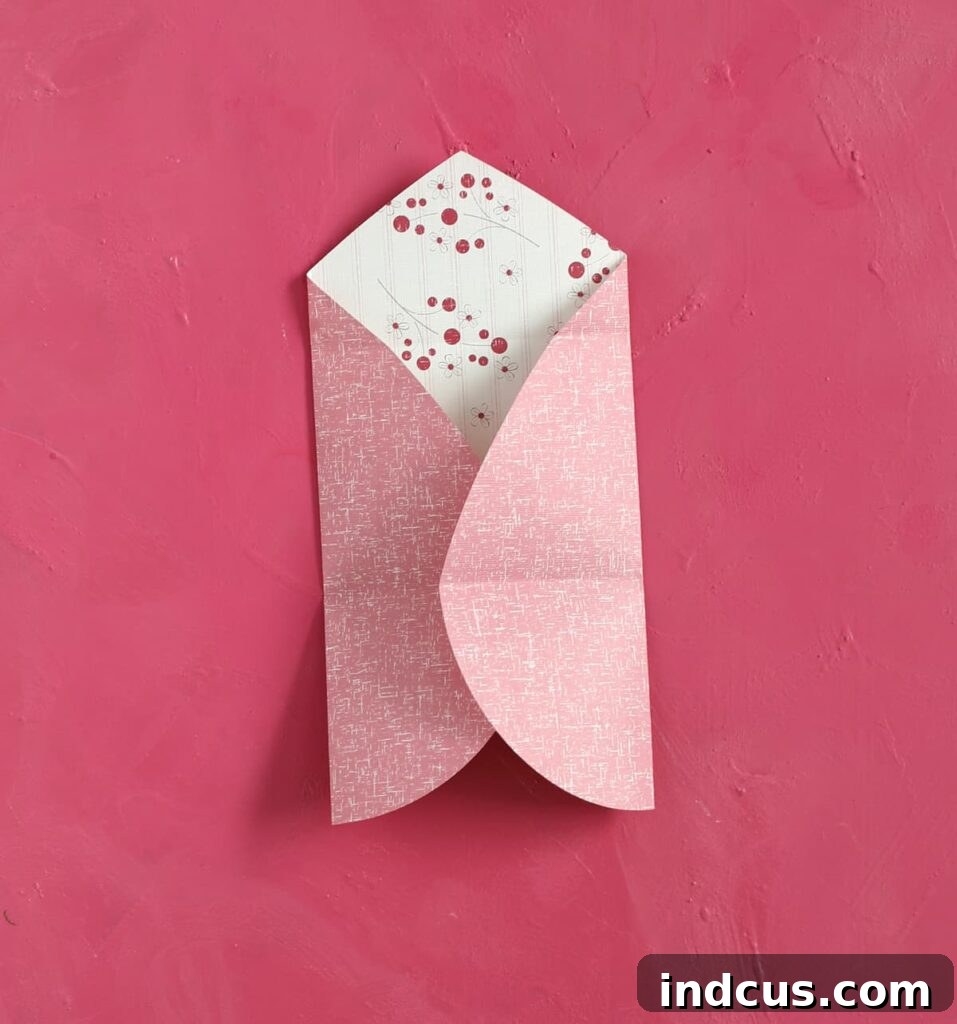 Craft Your Own Heart Envelope 4 Carefully fold the two outer, rounded edges of the inverted paper heart inward, meeting in the center to form a straight vertical line.