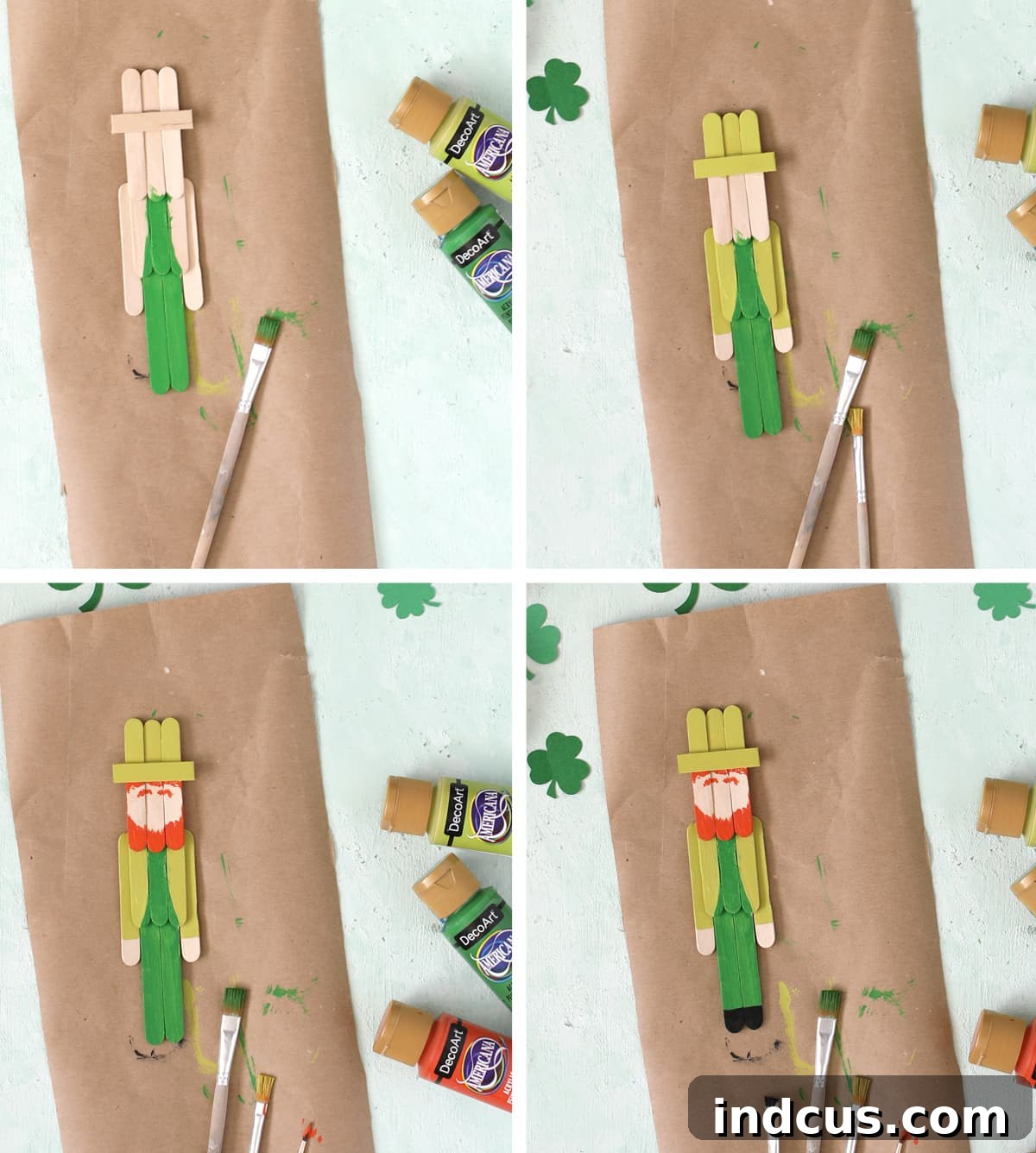 A partially painted popsicle stick leprechaun showing green hat, jacket, legs, and orange beard and hair in progress.