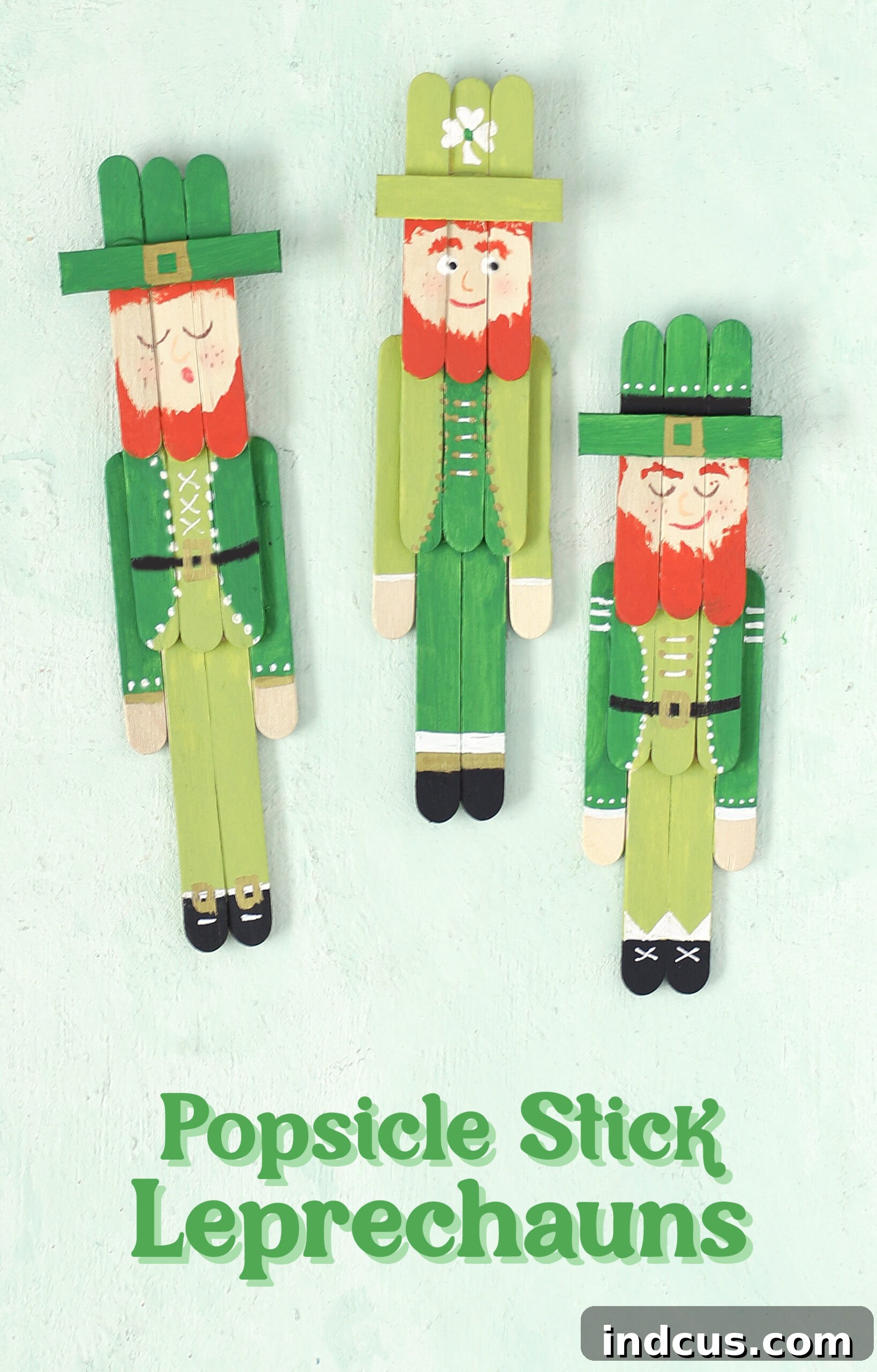 A vibrant, close-up photograph of a finished popsicle stick leprechaun craft, showcasing intricate details and green St. Patrick's Day theme.