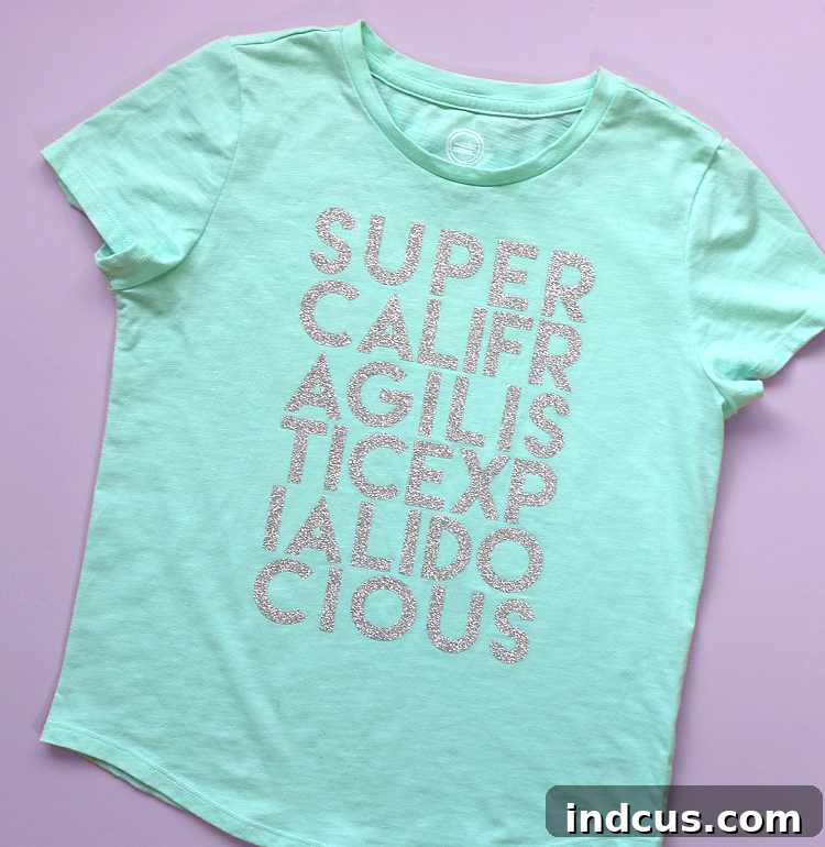 DIY Mary Poppins 'Supercalifragilisticexpialidocious' shirt for Disneyland in silver glitter HTV on a mint tee