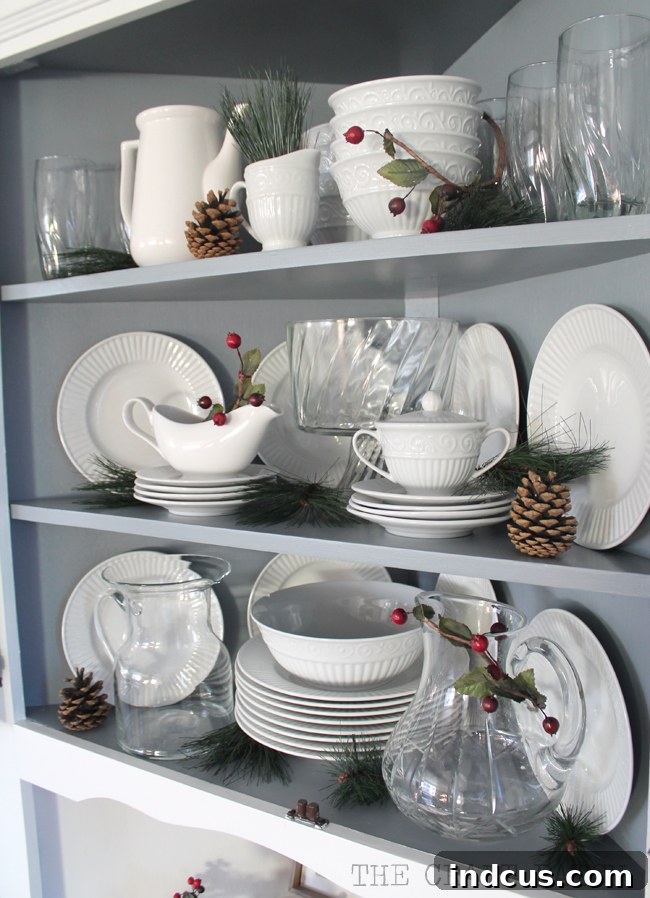 Our Christmas Wonderland 12 Corner hutch beautifully decorated for Christmas with festive greenery and holiday accents.