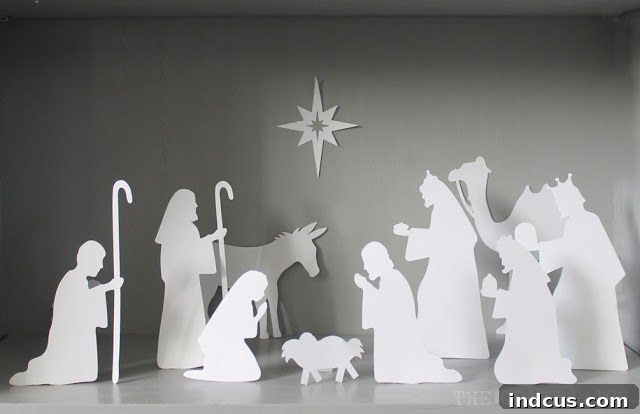 Our Christmas Wonderland 17 Close-up of an easy nativity scene made of white paper, showcasing intricate details cut with a Silhouette or Cricut machine.
