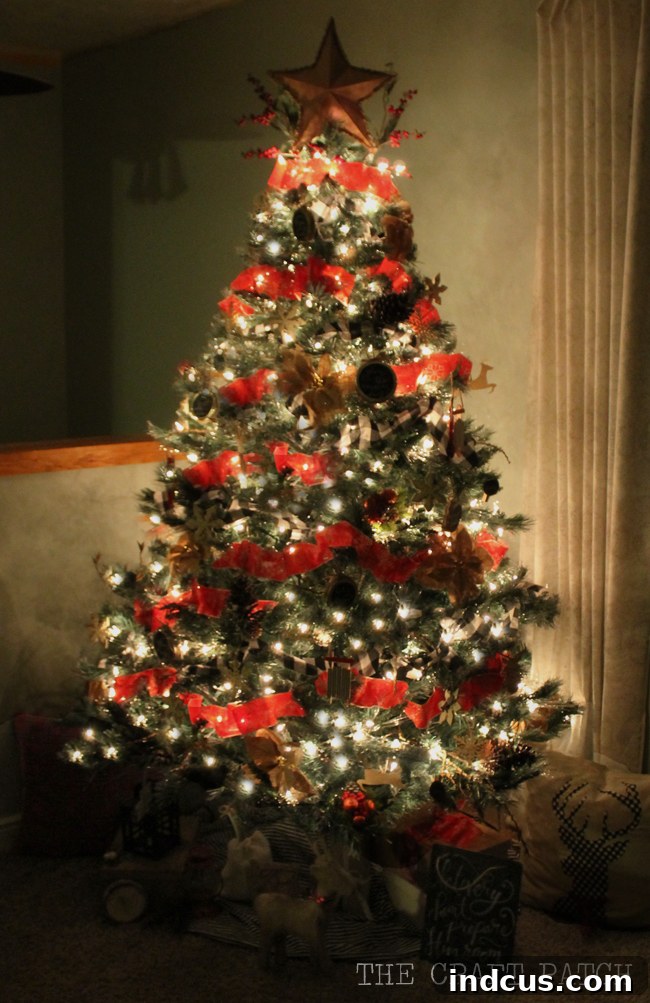 Our Christmas Wonderland 6 Beautiful Christmas tree decorated with rustic red ribbon, creating a cozy and traditional living room ambiance.