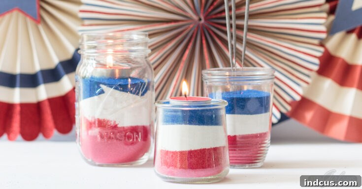 Glass jars filled with layers of red, white, and blue sand art, topped with tea candles