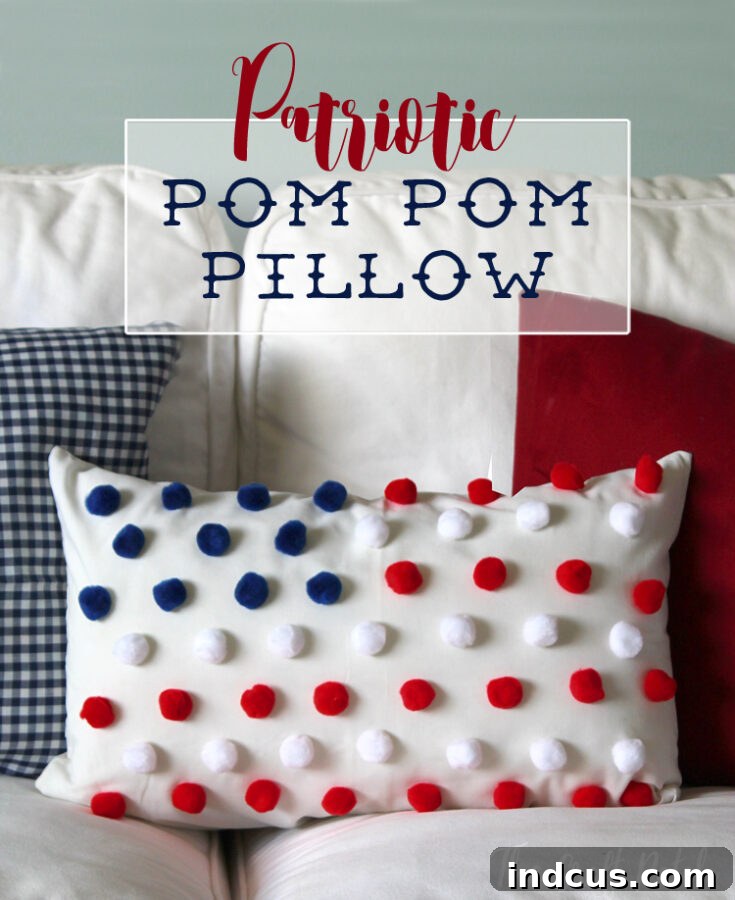 Red, white, and blue pom pom flag pillow on a sofa