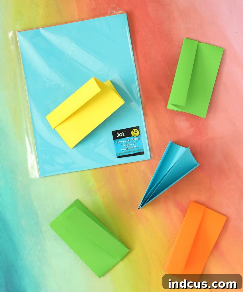 The ideal type of paper for crafting the best paper poppers, showing colorful copy paper.
