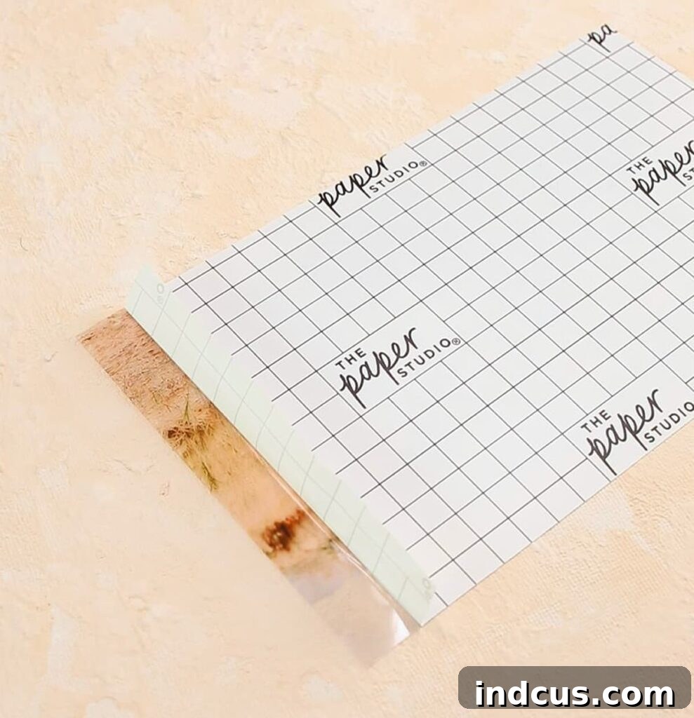 Applying clear sticker paper to glass jar