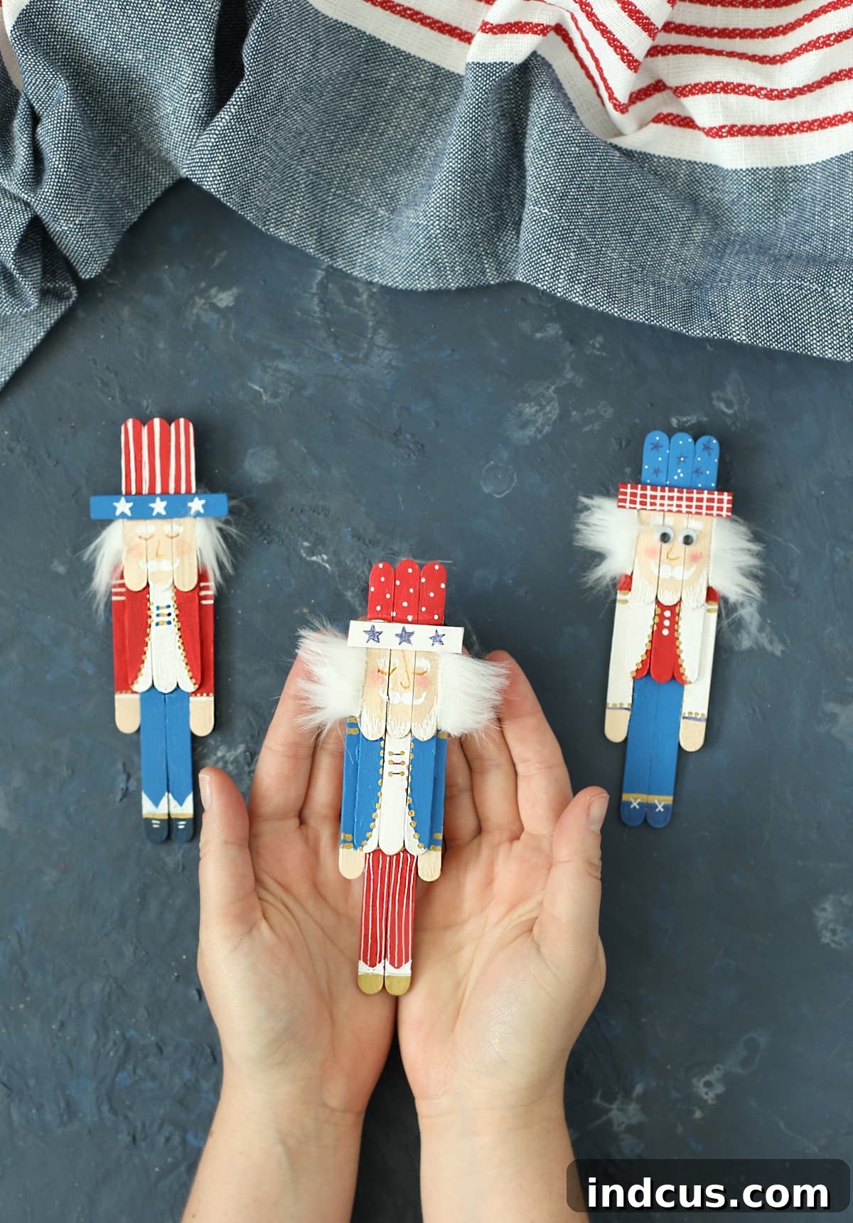 A group of finished Fourth of July Uncle Sam crafts made from popsicle sticks, showcasing different details