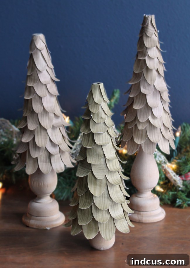 A collection of beautifully crafted DIY Christmas cone trees, adorned with faux wood petals, showcasing their elegant and rustic charm as holiday decor centerpiece
