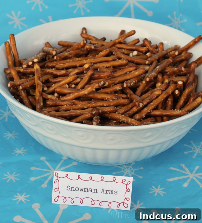 HK Anderson Salty Stix pretzels, elegantly presented as 'Snowman Arms,' offering a wonderfully simple and perfectly themed party food for any snowman celebration.
